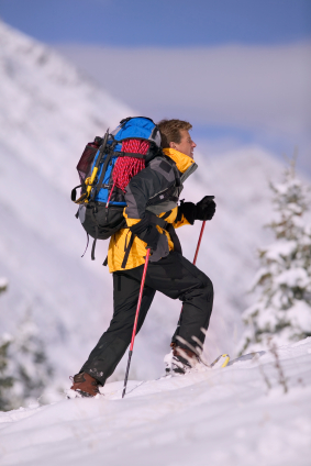 backpacker on snowshoes